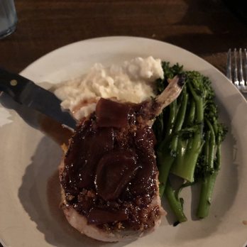 The Loft - The herb pork chop with garlic mashed potatoes and broccolini - Comedy Clubs Near Me - Columbus, Georgia