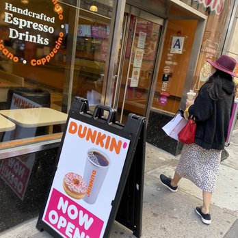 Dunkin' - a woman walking past a dunkin donut shop - Donuts Near Me - New York, New York Dunkin' - a woman walking past a dunkin donut shop - Donuts Near Me - New York, New York