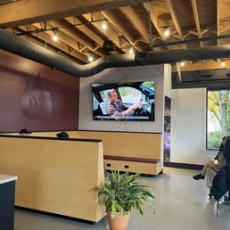 The seating, open space with small tables and booths