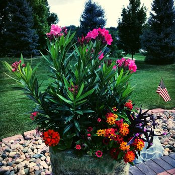 Eden Artistry - a pot of flowers on a brick patio - Landscaping Near Me - Omaha, Nebraska Eden Artistry - a pot of flowers on a brick patio - Landscaping Near Me - Omaha, Nebraska