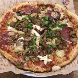 My pizza with red sauce, mozzarella, ricotta, spicy sausage, salami, mushrooms, green peppers, & roasted garlic. Giant hunks!