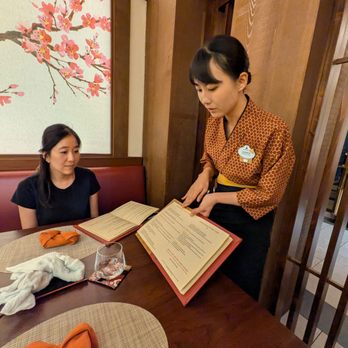 EPCOT - Our server and cast member Eriko, from Fukuoka, Japan, explaining Takumi-Tei's menu to us. Inside the washi paper room, EPCOT, Disney World. - Amusement Parks Near Me - Lake Buena Vista, Florida EPCOT - Our server and cast member Eriko, from Fukuoka, Japan, explaining Takumi-Tei's menu to us. Inside the washi paper room, EPCOT, Disney World. - Amusement Parks Near Me - Lake Buena Vista, Florida