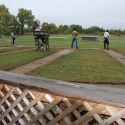 Metro Gun Club - Trap house and 3 shooters with staff member in chair to score and "pull" the clay pigeons.