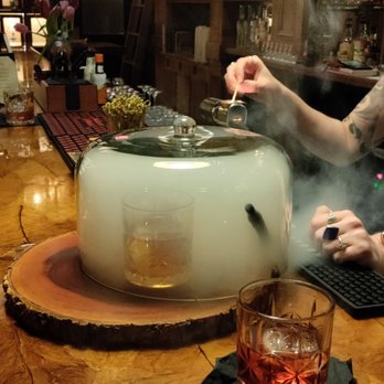 Trophy Room Bourbon Bar - Oh yeah! An Old Fashioned under glass getting smoked - Whiskey Bars Near Me - Winston-Salem, North Carolina Trophy Room Bourbon Bar - Oh yeah! An Old Fashioned under glass getting smoked - Whiskey Bars Near Me - Winston-Salem, North Carolina