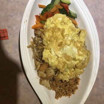 Noodle Street - Tom Yum Pad Thai with fried omelette on top - Thai Near Me - Boston, Massachusetts Noodle Street - Tom Yum Pad Thai with fried omelette on top - Thai Near Me - Boston, Massachusetts