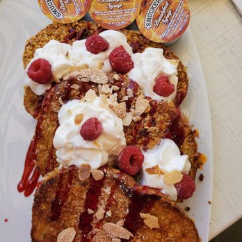 Broken Yolk Cafe - Extra crispy French toast, cooked with frosty flakes for the crispness, topped with almonds,raspberries and whip cream. - Breakfast & Brunch Near Me - Del Mar, California Broken Yolk Cafe - Extra crispy French toast, cooked with frosty flakes for the crispness, topped with almonds,raspberries and whip cream. - Breakfast & Brunch Near Me - Del Mar, California