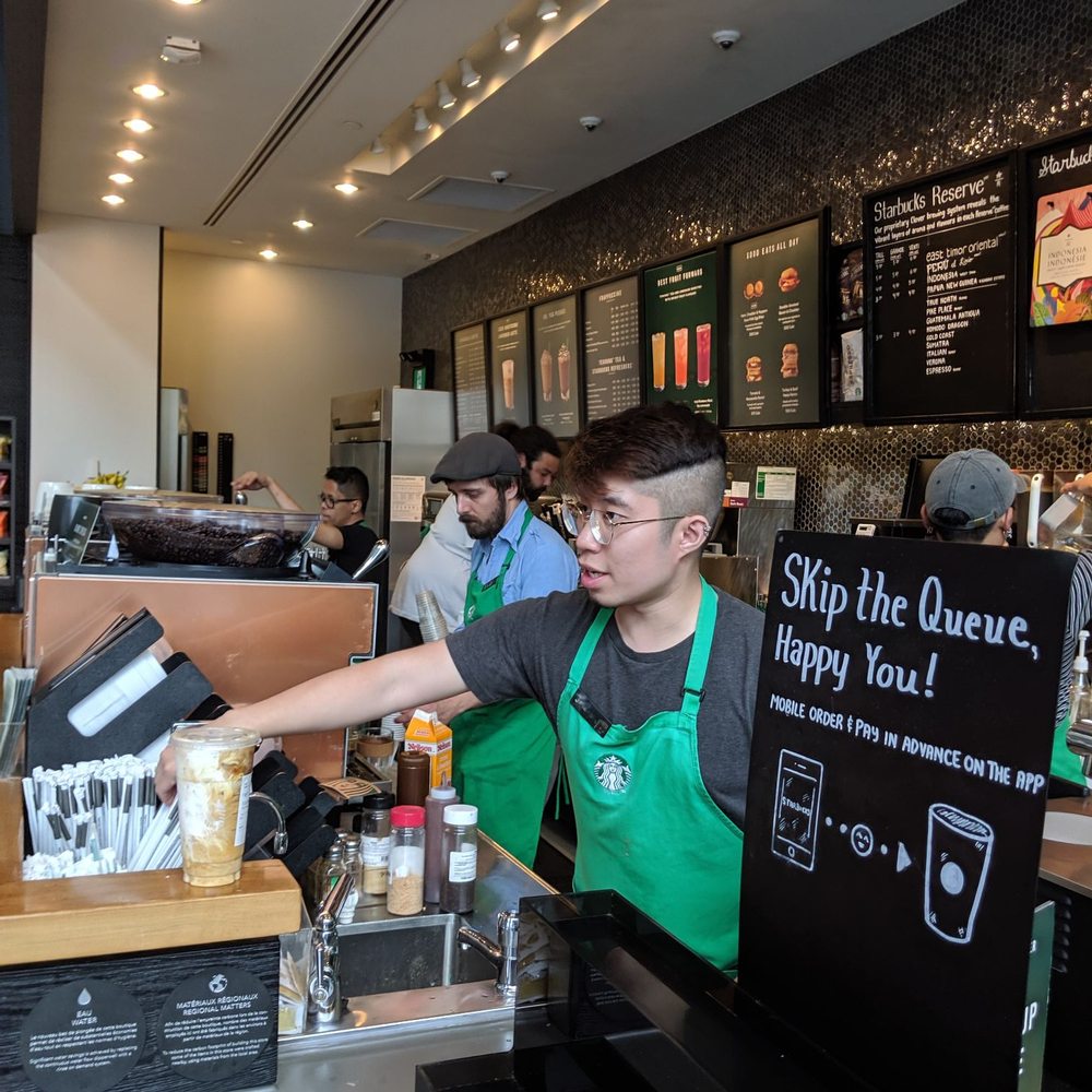 a bari serving a customer at the counter a bari serving a customer at the counter