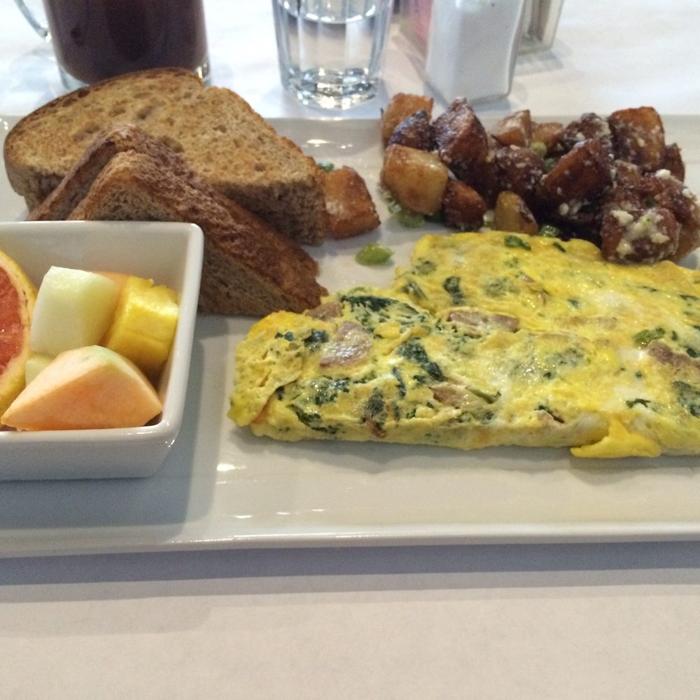 Kitchen 73 - an omelet, fruit, and toast on a plate - Breakfast & Brunch Near Me - Laval, Quebec Kitchen 73 - an omelet, fruit, and toast on a plate - Breakfast & Brunch Near Me - Laval, Quebec