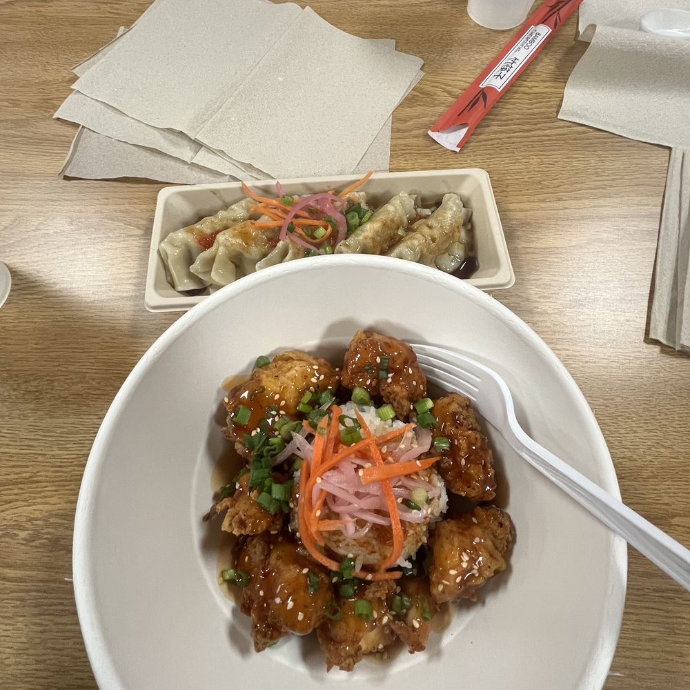 Orange chicken bites with white rice, pork pot stickers. Orange chicken bites with white rice, pork pot stickers.