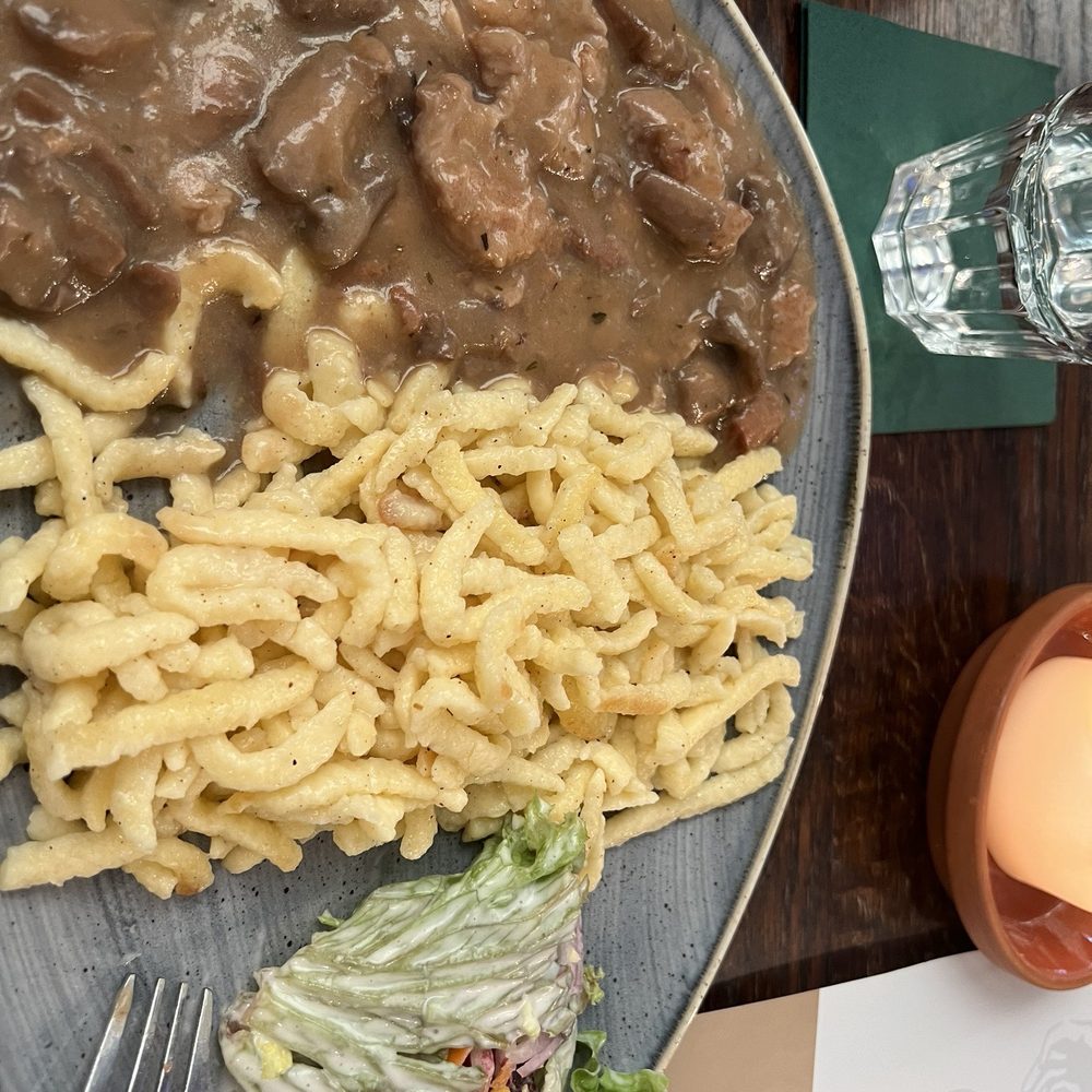 Bitburger Wirtshaus - Chicken cutlets in a mushroom cream sauce with spaetzle - Beer Garden Near Me - Trier, RP