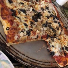 a pizza with olives and cheese