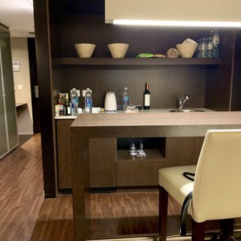 Hotel Madero - Our kitchen, dining table and chairs, cabinets, closet, and door. - Hotels Near Me - Buenos Aires, C