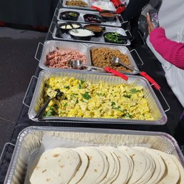 Breakfast Taco Bar- Jerk Chicken, Glazed Ham, Impossible Sausage, Jerk Lamb and Eggs.  Their toppings are !