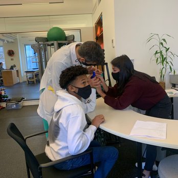 Spear Physical Therapy - Doctor and OT working together on adjusting hand / thumb brace - Physical Therapy Near Me - New York, New York