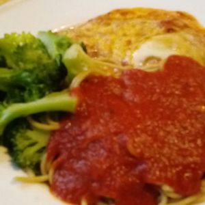 Photo of Village Natural - New York, NY, United States. Veggie cutlet parmagiana with tomato sauce and melted muenster cheese whole wheat spaghetti and steamed broccoli