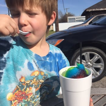 Texas Snow Store Shaved Ice - The little guy taking his first bite of his rainbow snow cone with the sun in his eyes - Shaved Ice Near Me - Watauga, Texas Texas Snow Store Shaved Ice - The little guy taking his first bite of his rainbow snow cone with the sun in his eyes - Shaved Ice Near Me - Watauga, Texas