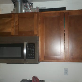 Cut-Right Construction - a microwave and cabinets in a kitchen - General Contractors Near Me - Fremont, California
