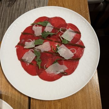 Maison Boulud - Bison Carpaccio Arugula, Parmesan and Black Garlic - French Near Me - Montreal, Quebec Maison Boulud - Bison Carpaccio Arugula, Parmesan and Black Garlic - French Near Me - Montreal, Quebec