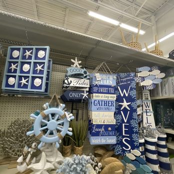 Big Lots - Coastal-themed home decor items, including signs with messages and nautical ornaments, are displayed on store shelves. - Department Stores Near Me - Schererville, Indiana