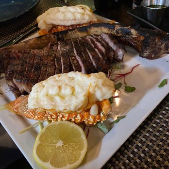 Primal By Mia - Surf and turf for two - 32oz Tomahawk Steak and twin 16oz lobster tails. - Seafood Near Me - Cape May, New Jersey Primal By Mia - Surf and turf for two - 32oz Tomahawk Steak and twin 16oz lobster tails. - Seafood Near Me - Cape May, New Jersey