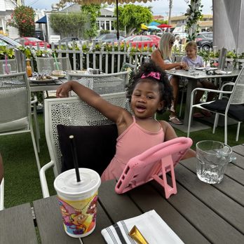Sugar and Scribe  - Julia enjoying her apple juice getting ready for her pancakes and bacon - Bakeries Near Me - La Jolla, California