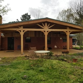 Sean Bruno Construction - a covered patio with a table and chairs - General Contractors Near Me Sean Bruno Construction - a covered patio with a table and chairs - General Contractors Near Me