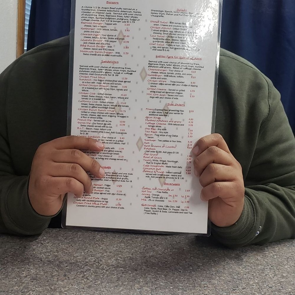 a man holding up a menu a man holding up a menu