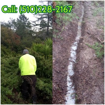Monarch Maintenance - a man in a yellow jacket and black pants working on a muddy road - Gutter Services Near Me
