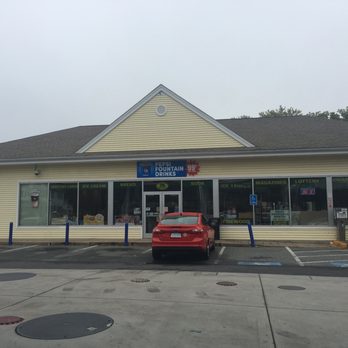 Mobil - a car parked in front of a store - Gas Stations Near Me - Woburn, Massachusetts