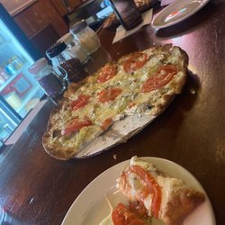 Spud’s Bistro & Pizzeria - Cheese pizza added some veggies. Meat pizza in background.
