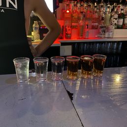 a bartender mixing a drink at a bar