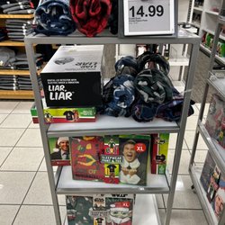 Kohl's - A Kohl's holiday clearance sale aisle display with Elf and Star Wars items.