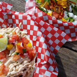 two tacos on a picnic table