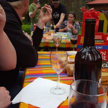 China Bend Vineyards - people sitting at a picnic table - Wineries Near Me - Kettle Falls, Washington China Bend Vineyards - people sitting at a picnic table - Wineries Near Me - Kettle Falls, Washington