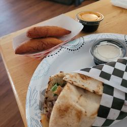 Golden Roll Shawarma - 2 empanadas and a chicken schwarma wrap for lunch. Be careful asking for extra onions. They use red onions in their wraps.