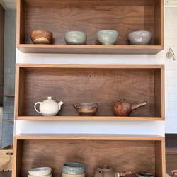 Favorite Coffee Museum - Wall of handmade pottery for sale and ambiance