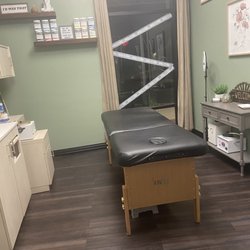 Waxing By Ashley - Treatment room. Sink and supplies to the left. Mini fridge with some snacks to the right. Cutely decorated and organized!