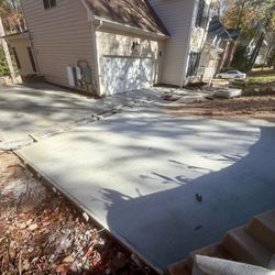 North Wake Concrete - Using Concrete Pump To Pour A Driveway Addition With A 6in Wide x 40ft Long Trench Drain In the Driveway