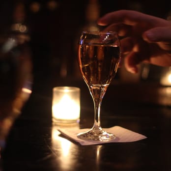 Merchants NY - a person holding a glass of wine - New American Near Me - New York, New York Merchants NY - a person holding a glass of wine - New American Near Me - New York, New York