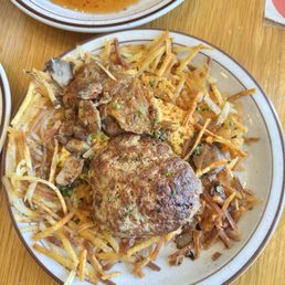 Hash Browns with onions, mushrooms and cheese and a sausage patty.