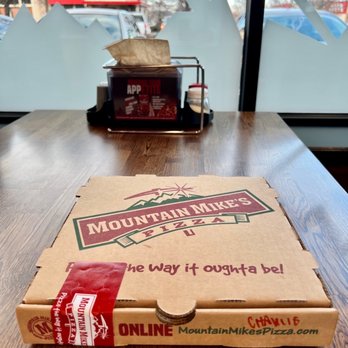Mountain Mike's Pizza - a pizza box on a table - Pizza Near Me - Meridian, Idaho Mountain Mike's Pizza - a pizza box on a table - Pizza Near Me - Meridian, Idaho