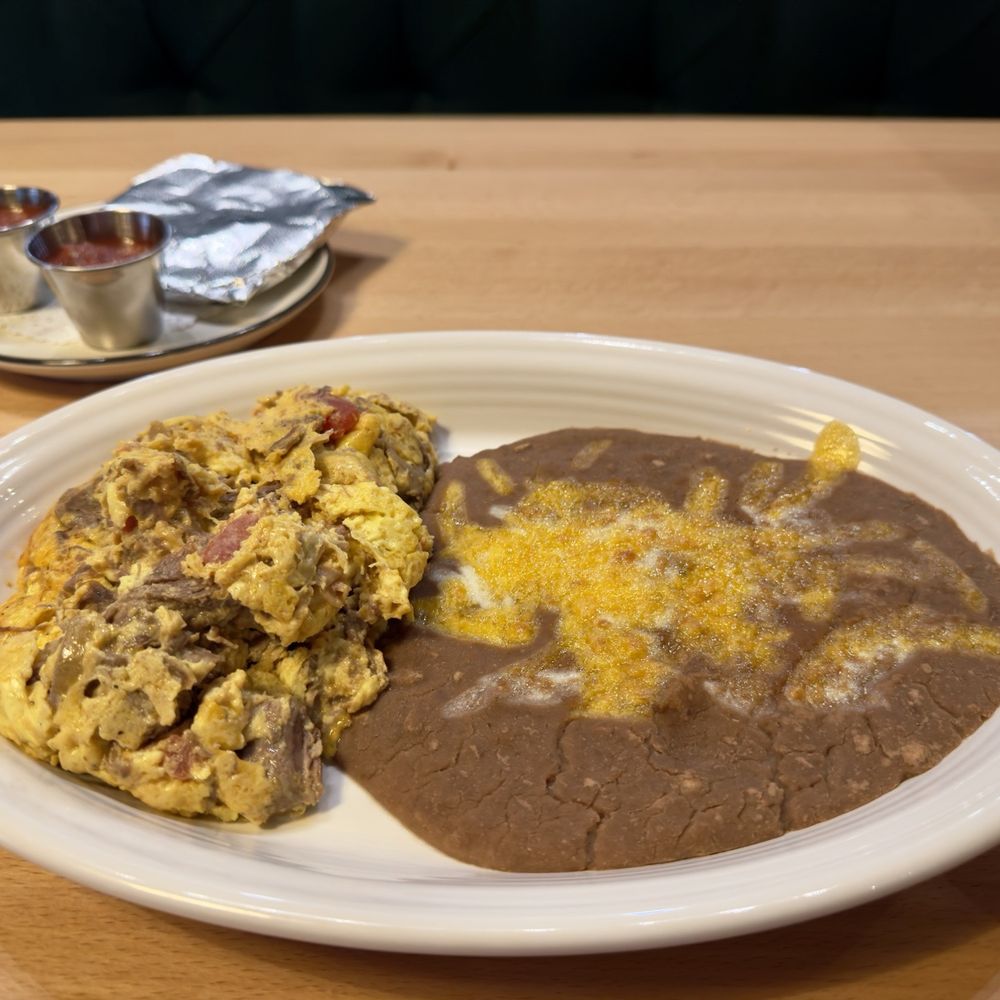 Janet’s Cafe - Machaca and Eggs - Shredded beef, tomato, onions, bell peppers served with salsa and corn or flour tortillas. - Coffee & Tea Near Me - Eagle, Idaho Janet’s Cafe - Machaca and Eggs - Shredded beef, tomato, onions, bell peppers served with salsa and corn or flour tortillas. - Coffee & Tea Near Me - Eagle, Idaho