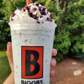 BIGGBY COFFEE - a hand holding a cup of coffee - Coffee & Tea Near Me - Spring Lake, Michigan