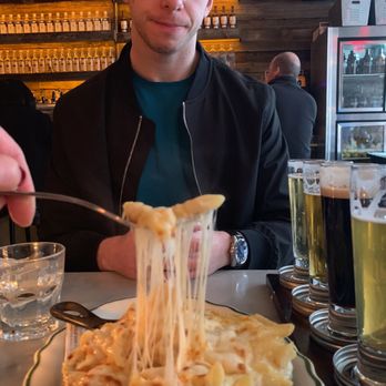 Jacob's Pickles - My boyfriend patiently waits for me to capture the perfect cheese pull (which didn't take long because the dish was SO cheesy) - Comfort Food Near Me - New York, New York Jacob's Pickles - My boyfriend patiently waits for me to capture the perfect cheese pull (which didn't take long because the dish was SO cheesy) - Comfort Food Near Me - New York, New York