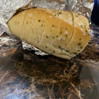Santino's Pizza - This is the piece of bread they gave us with our order of pasta. You can decided for yourself. - Pizza Near Me - Parlin, New Jersey