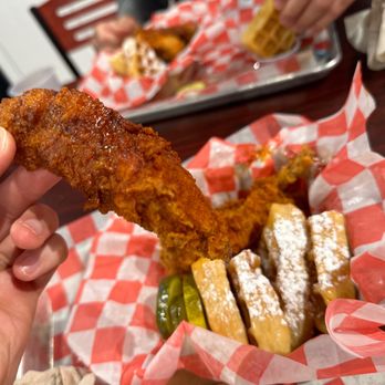 Hangry Joe's Hot Chicken - a hand holding a piece of fried chicken - Chicken Shop Near Me - Centreville, Virginia Hangry Joe's Hot Chicken - a hand holding a piece of fried chicken - Chicken Shop Near Me - Centreville, Virginia
