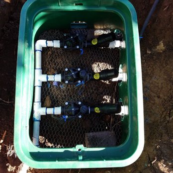 Superior Landscaping - a green container filled with water - Landscaping Near Me