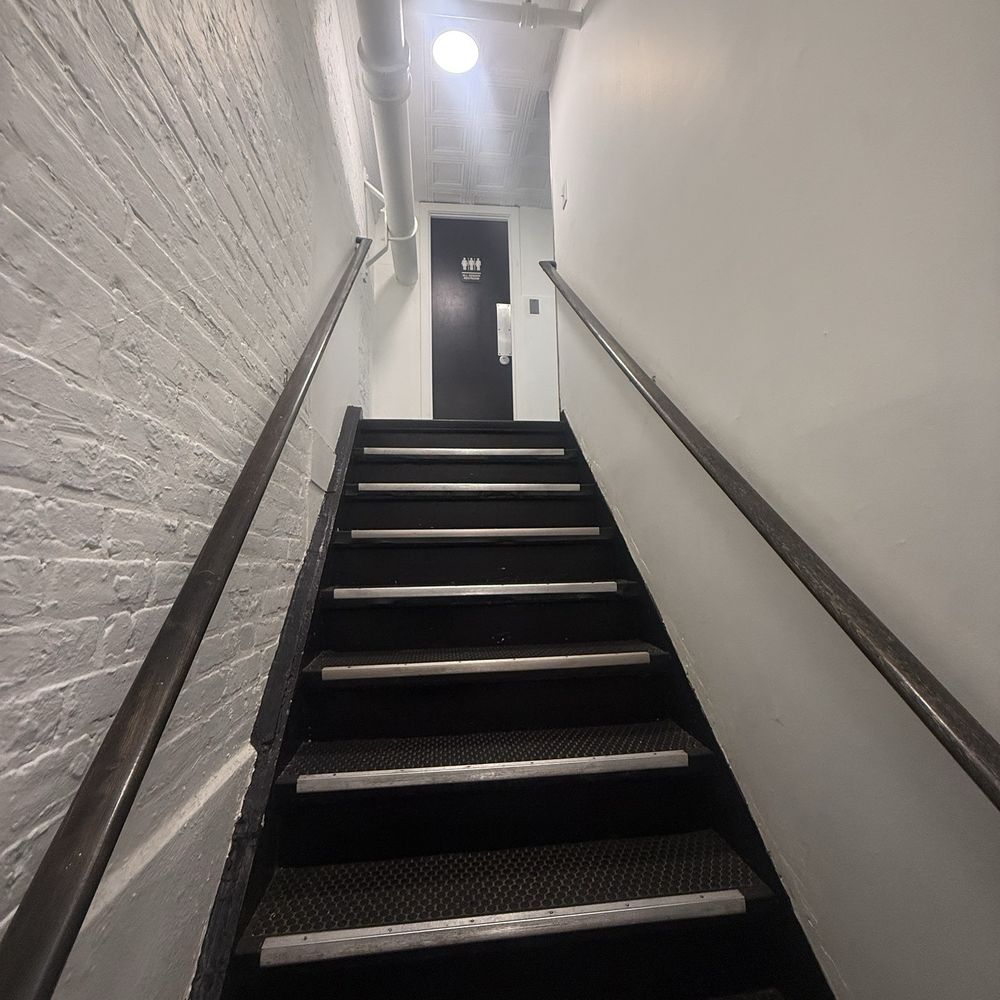 Stairs to the two restrooms up and away from the dining area