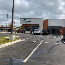 a parking lot with cars parked in front of it a parking lot with cars parked in front of it