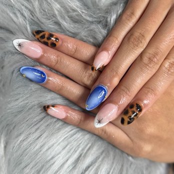 Glossy Nails Spa - Leopard print nails with vibrant blue ombré, tiny gold stars, and crisp white French tips. - Nail Salons Near Me - Tampa, Florida Glossy Nails Spa - Leopard print nails with vibrant blue ombré, tiny gold stars, and crisp white French tips. - Nail Salons Near Me - Tampa, Florida